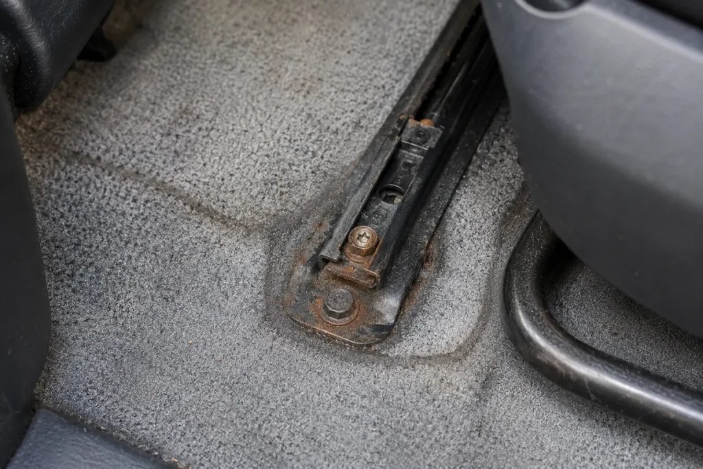 Flood car warning signs Houston - seat rail rust and bolt corrosion inside used car cabin